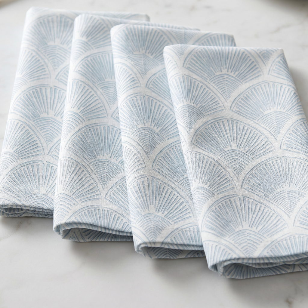 beach house dining table styled with light blue shell print linen napkins