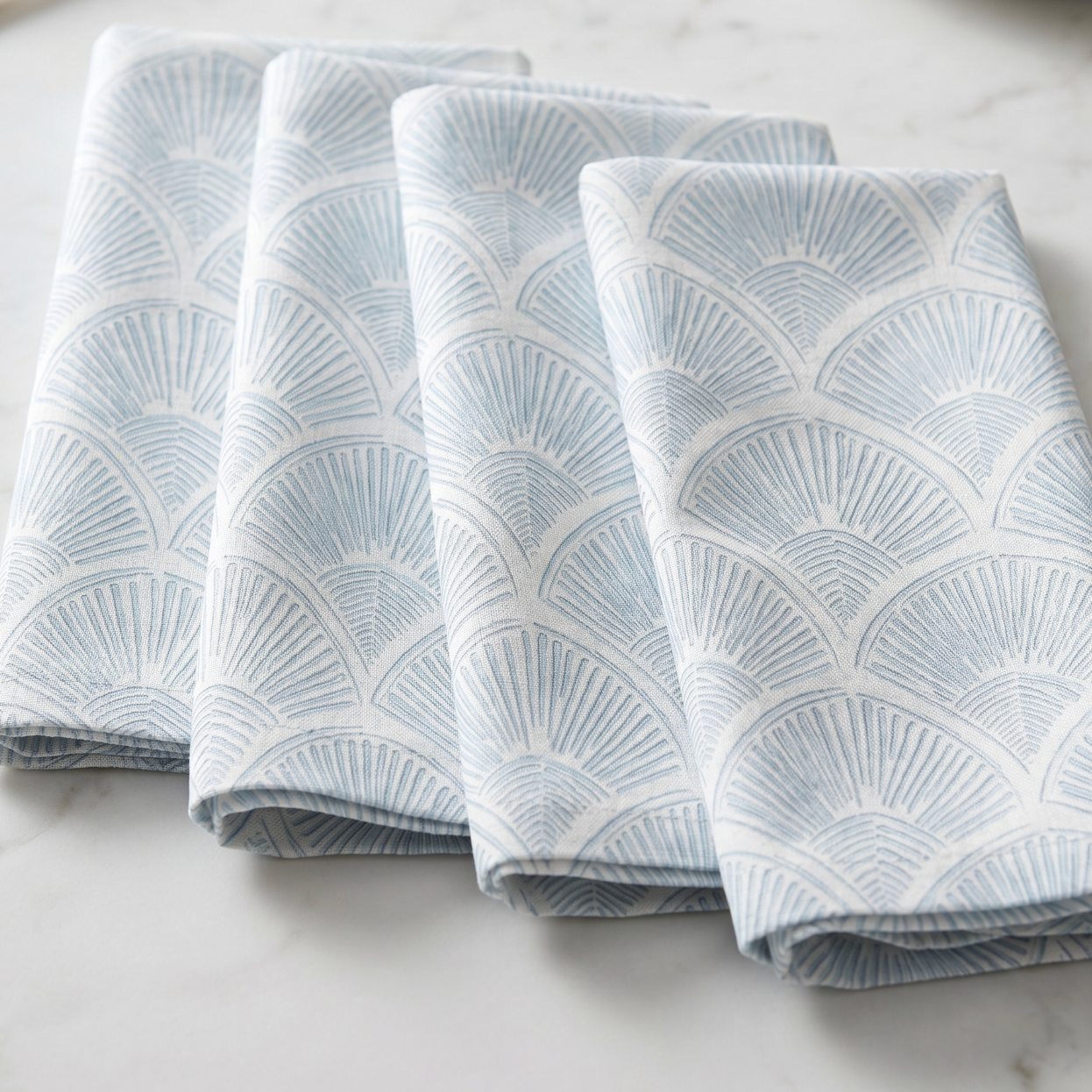 beach house dining table styled with light blue shell print linen napkins