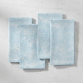 Coastal Tide Blue Linen Napkins Set of 4 with a soft ocean-wave pattern in light blue.