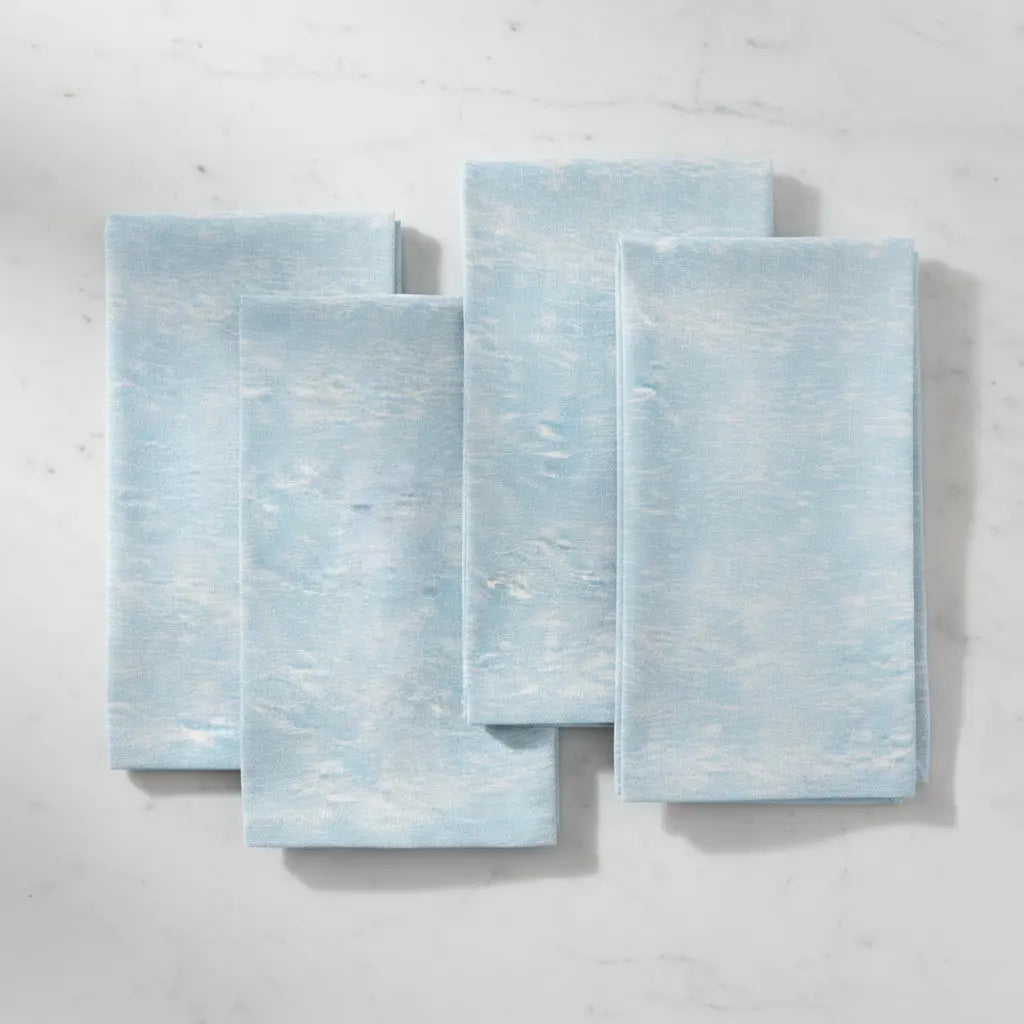 Coastal Tide Blue Linen Napkins Set of 4 with a soft ocean-wave pattern in light blue.