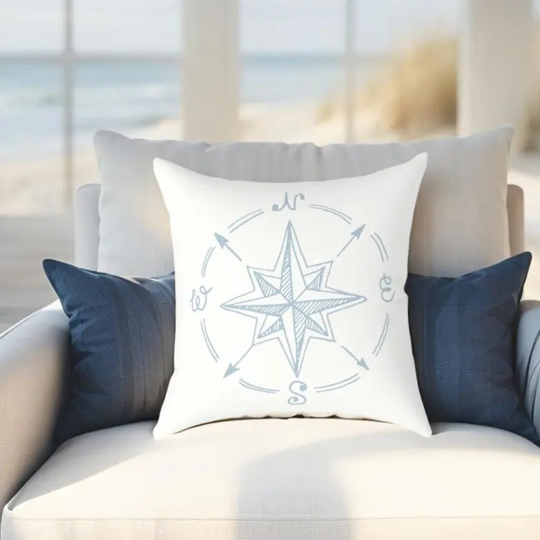 True North Throw Pillow featuring a blue compass rose on white fabric for coastal nautical decor.
