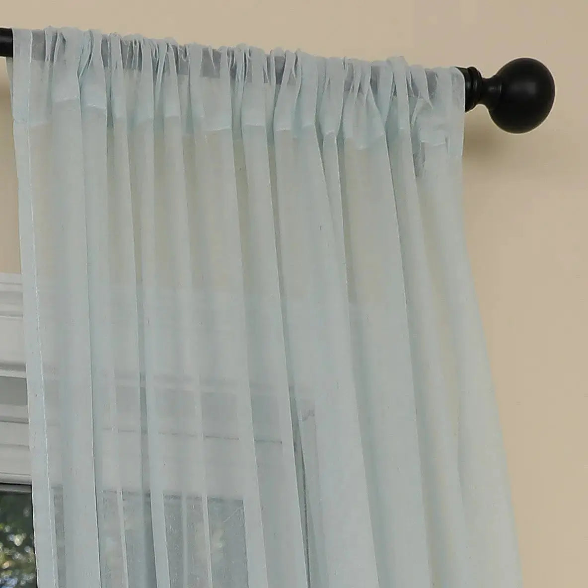 Closeup of ocean coral design on light blue semi sheer curtain fabric