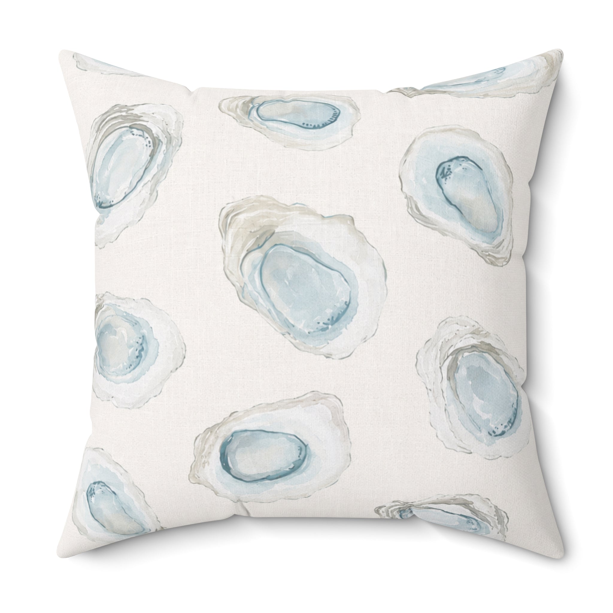 Light blue nautical oyster pattern throw pillow on a neutral couch in a bright coastal home.