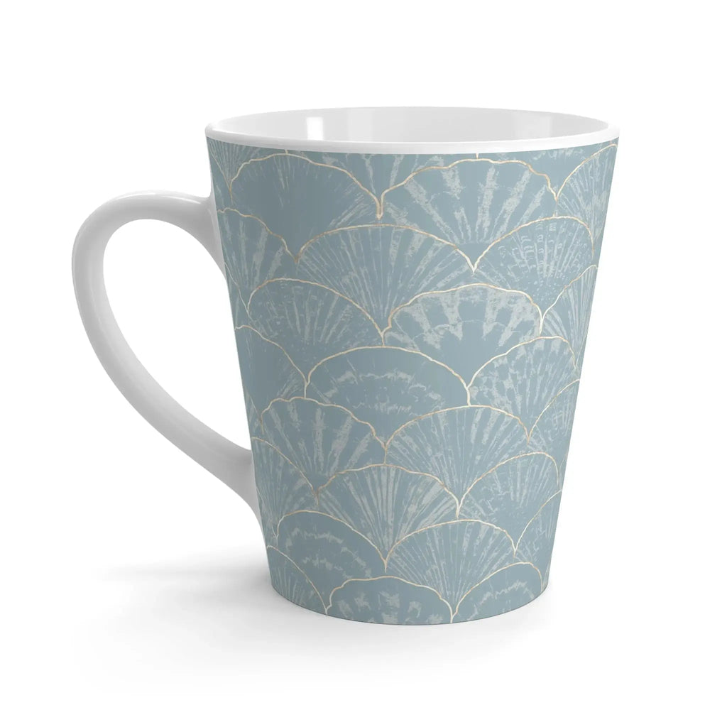 Closeup of blue seashell pattern on light blue ceramic coffee mug