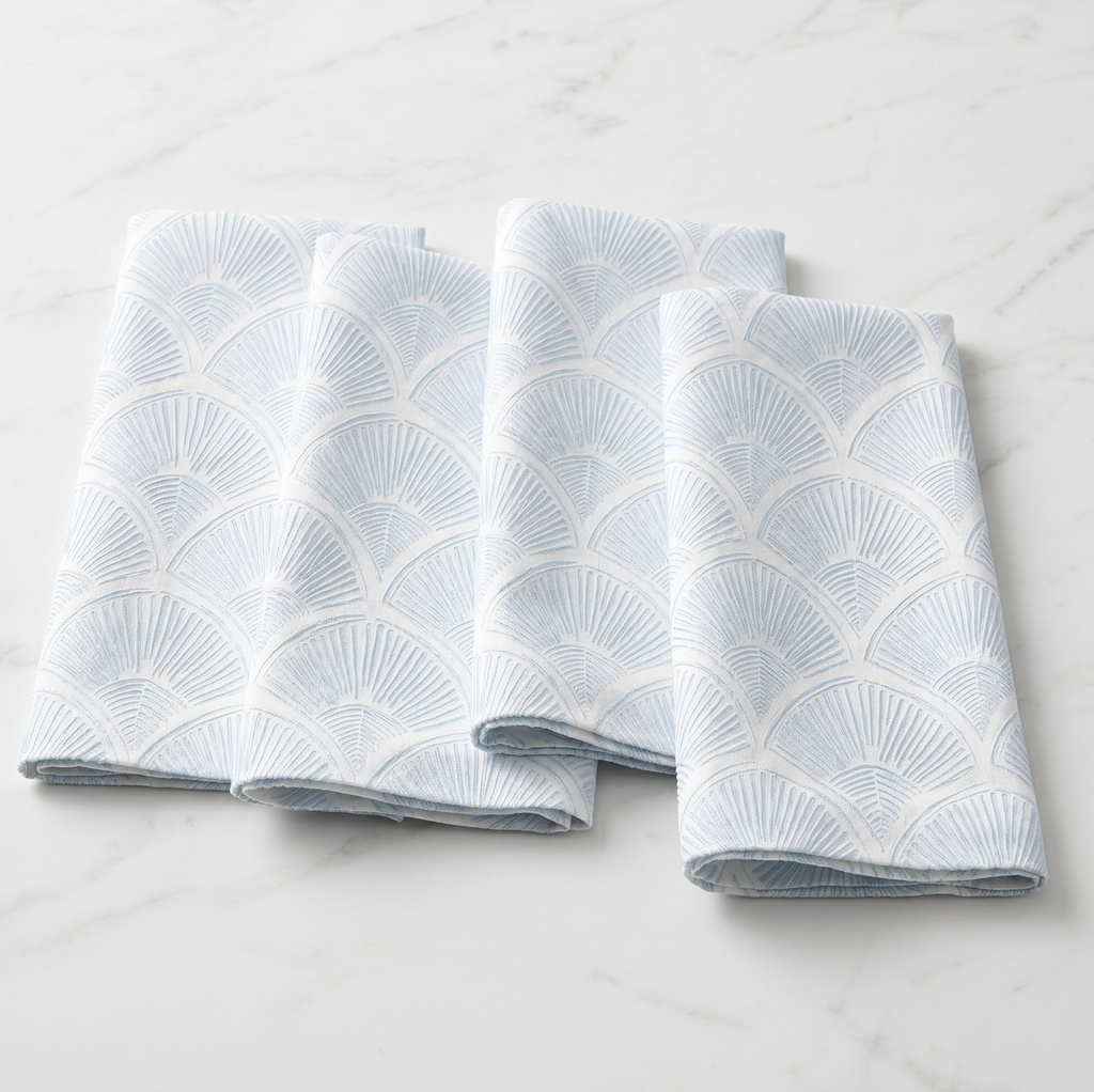 Summer coastal tablescape featuring shell pattern linen napkins