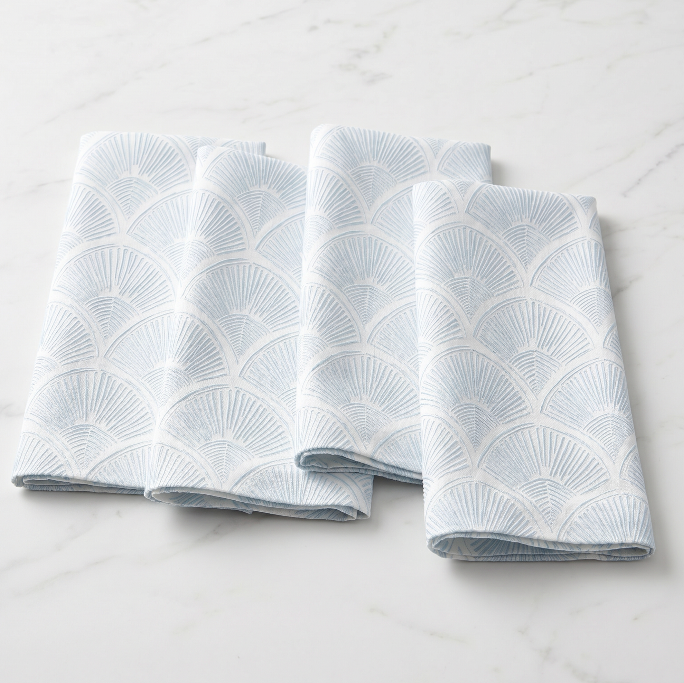 Summer coastal tablescape featuring shell pattern linen napkins