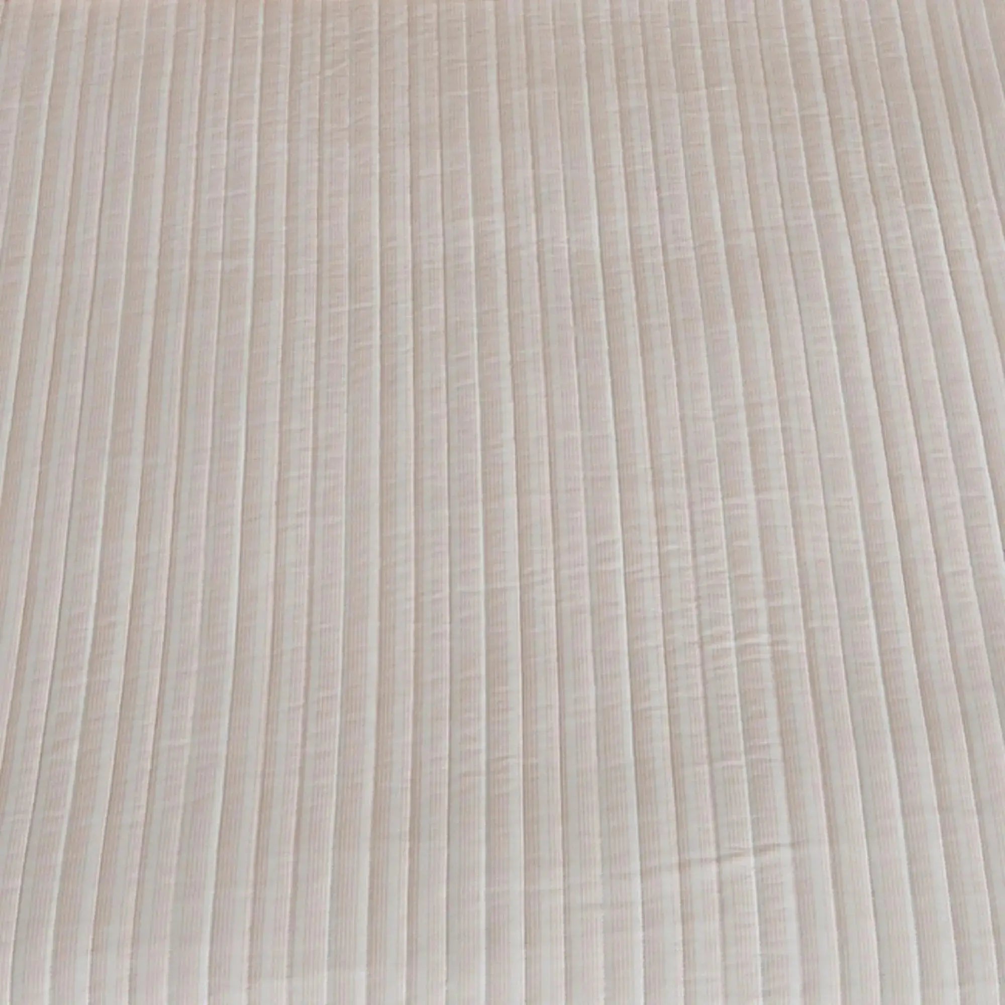 Light pink stripe quilt 3-piece set adding soft coastal color to a neutral bedroom