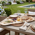 Rustic live‑edge charcuterie board set with sliced bread, cheeses, fruit, and crackers for indoor/ outdoor entertaining.