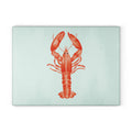 Red lobster illustration on a pale blue Harbor Lobster Glass Cutting Board.