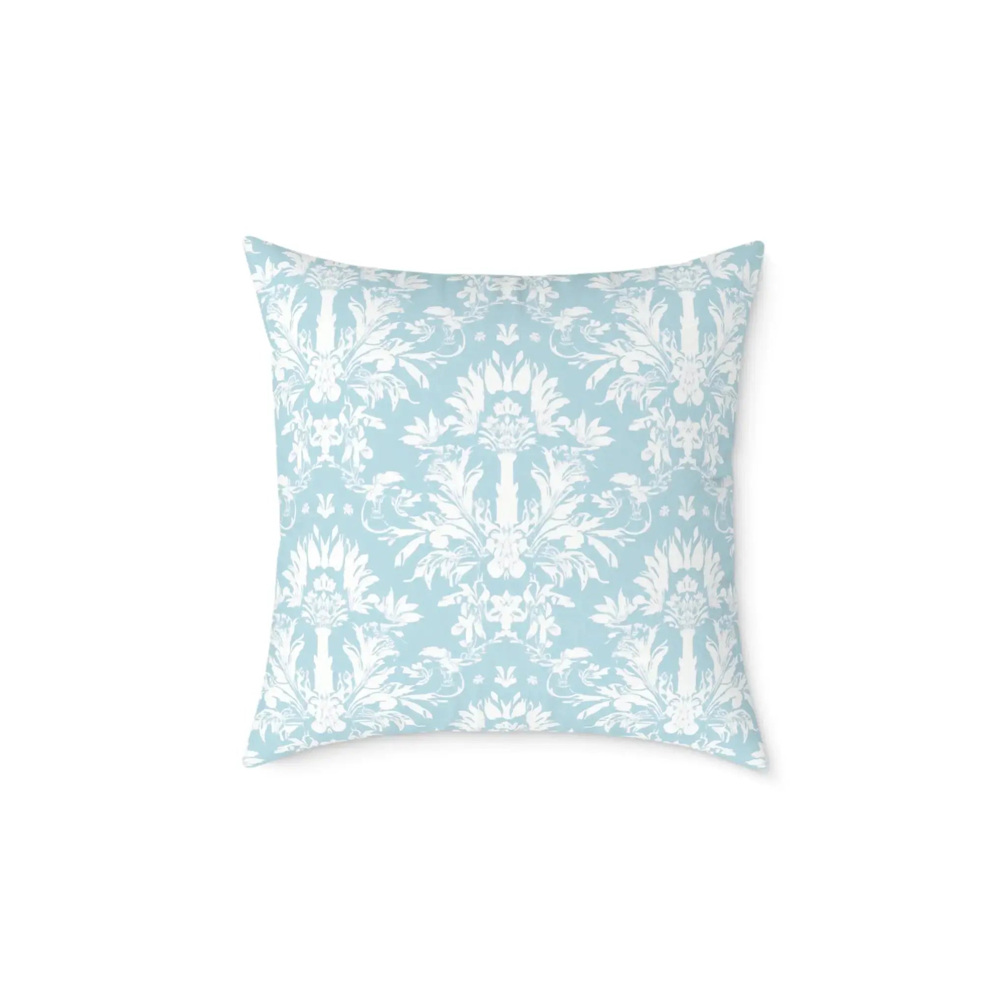 blue and white decorative pillow on a sunlit bedroom bed