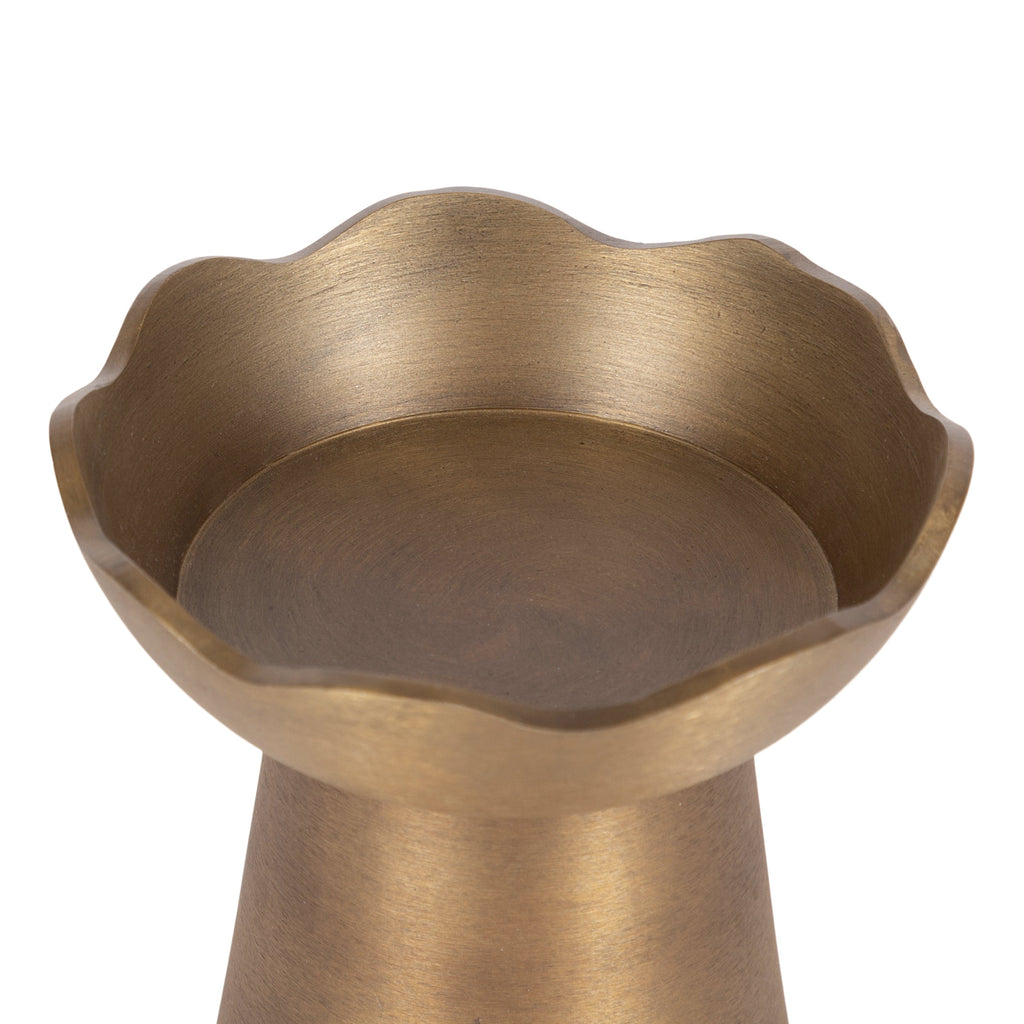 Luxury gold candle holders with a distinctive sculptural silhouette.