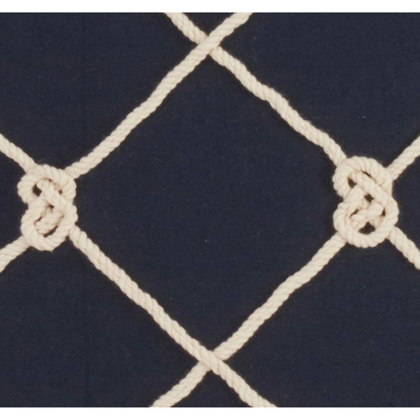 Deep navy rope net pillow that creates a strong focal point among neutral throw pillows.