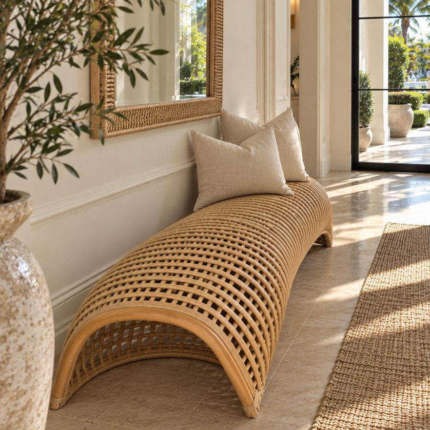 Minimalist natural rattan bench featuring an organic curved silhouette in a sunlit designer home.