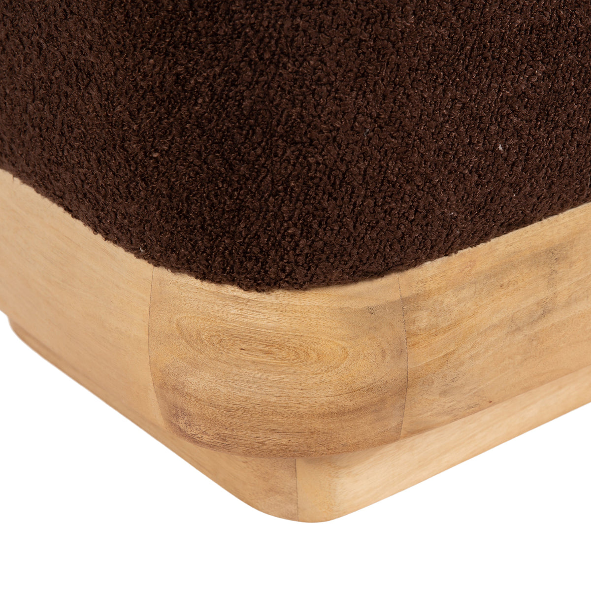 Modern brown ottoman with wooden base styled in a warm living room