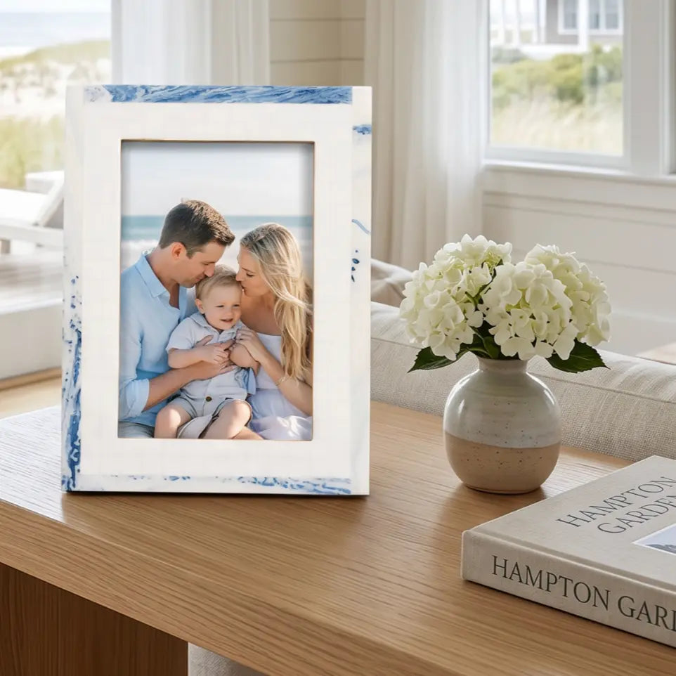 coastal gallery wall featuring blue and white wave frame