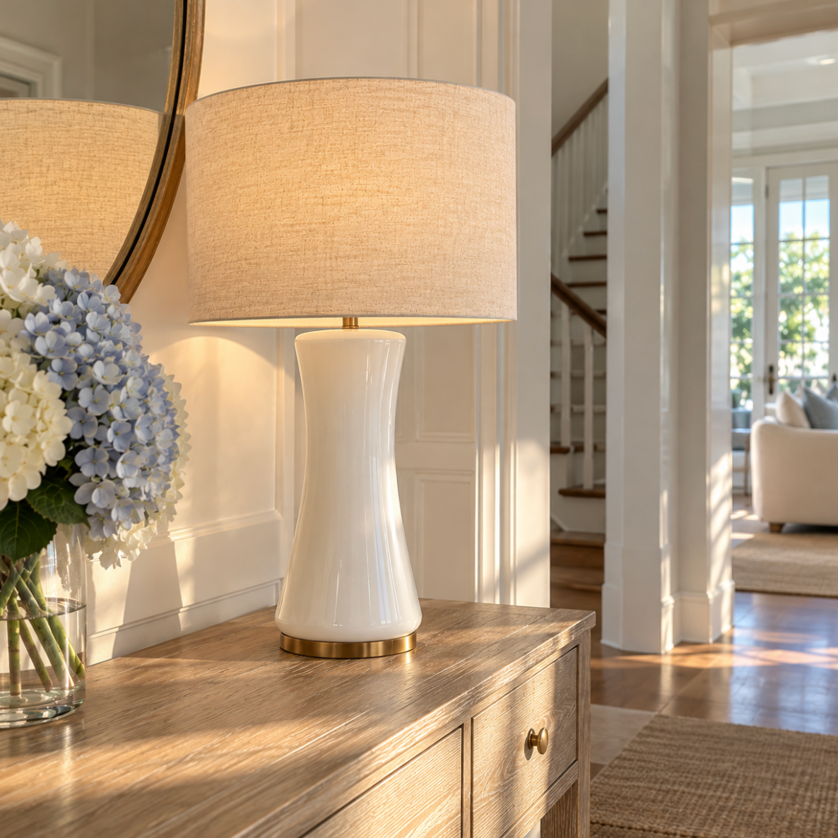 Modern coastal table lamp in white with gold decorative accents.