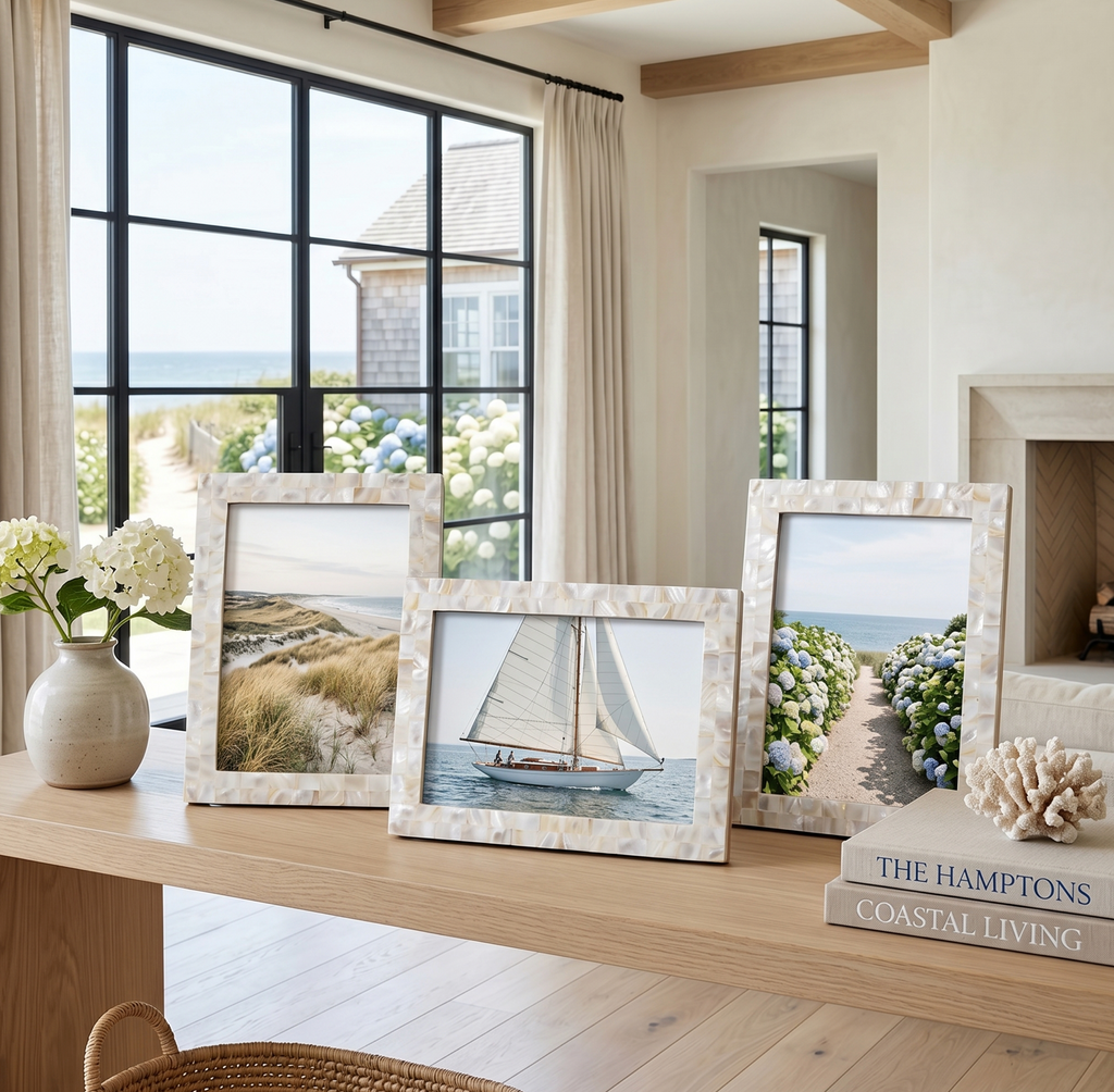 White mother of pearl decorative picture frame adding a coastal touch to a living room shelf.