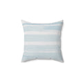 Blue and white striped coastal throw pillow styled for a neutral sofa in a beach inspired living room