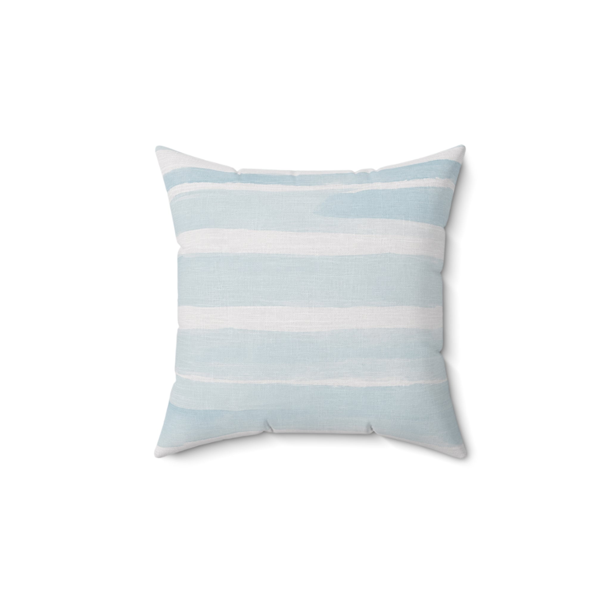 Blue and white striped coastal throw pillow styled for a neutral sofa in a beach inspired living room