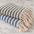 Nautical blue striped bath towel with natural ivory accents and knotted fringe detail
