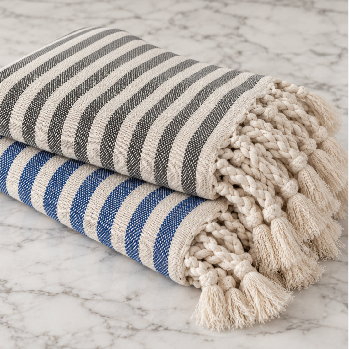 Nautical blue striped bath towel with natural ivory accents and knotted fringe detail