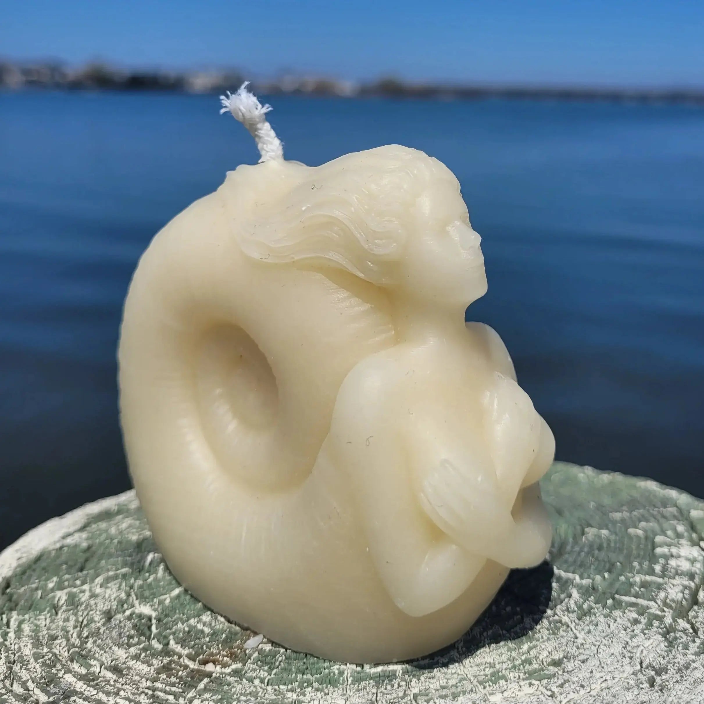Luxury coastal candle sculpture featuring mermaid and nautilus shell