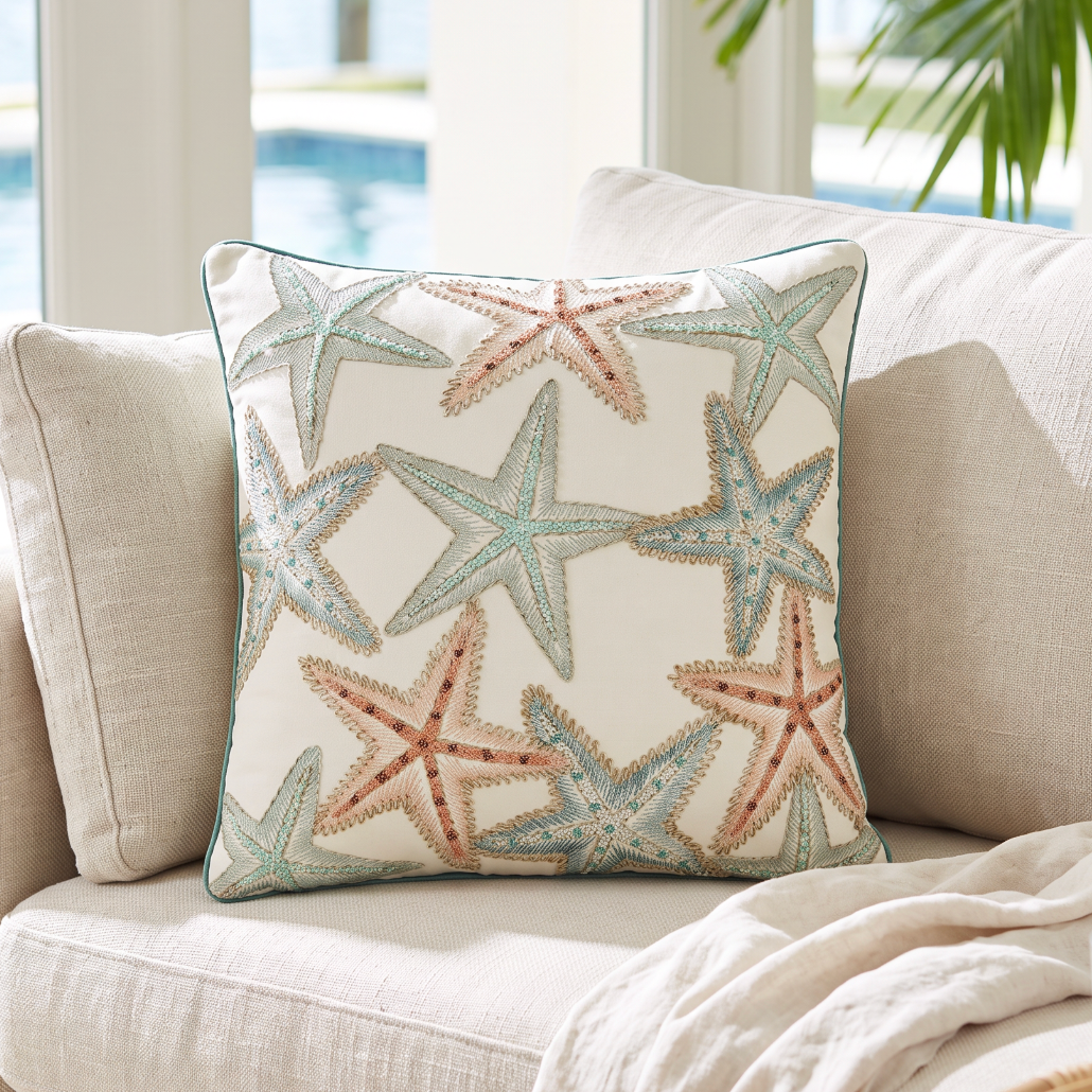 Nautical starfish print pillow adding a playful beachy vibe to chairs, couches, or benches.