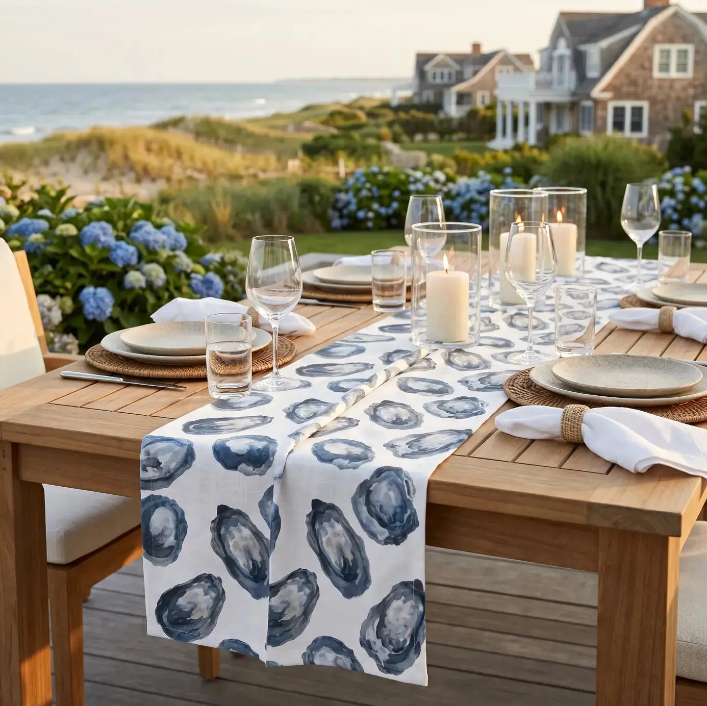 Navy oyster pattern table runner styled with shells in a beach house tablescape
