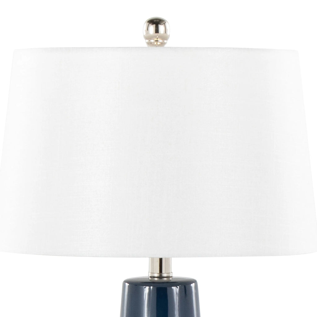 Navy table lamp adding a bold accent on a sofa side table in a beach house living room