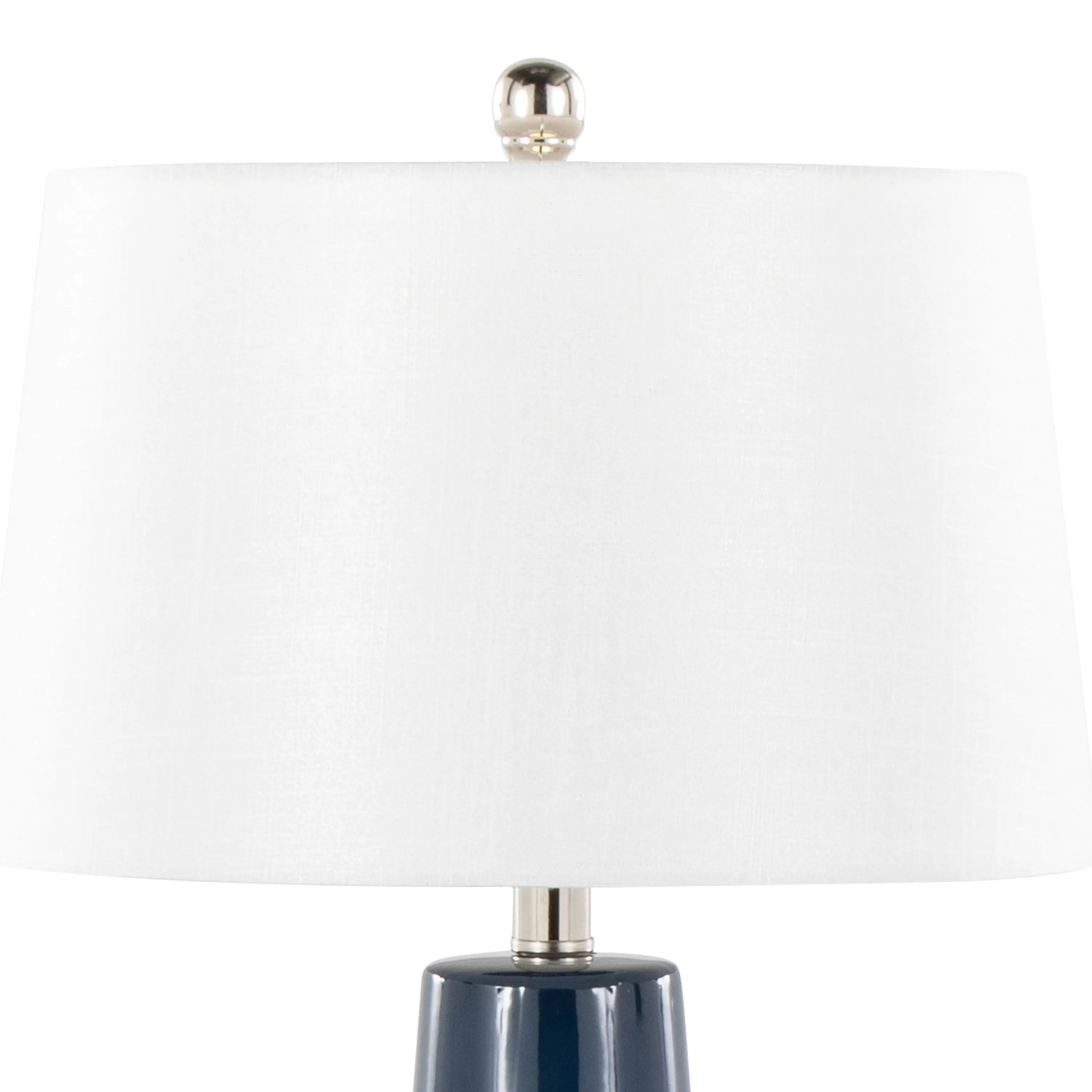 Navy table lamp adding a bold accent on a sofa side table in a beach house living room