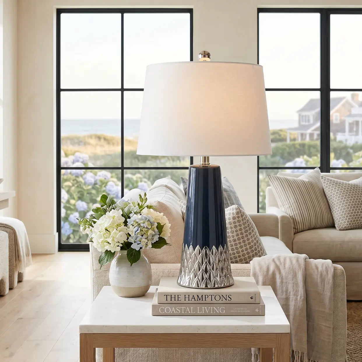 Navy table lamp styled in a beach house living room with coastal accessories