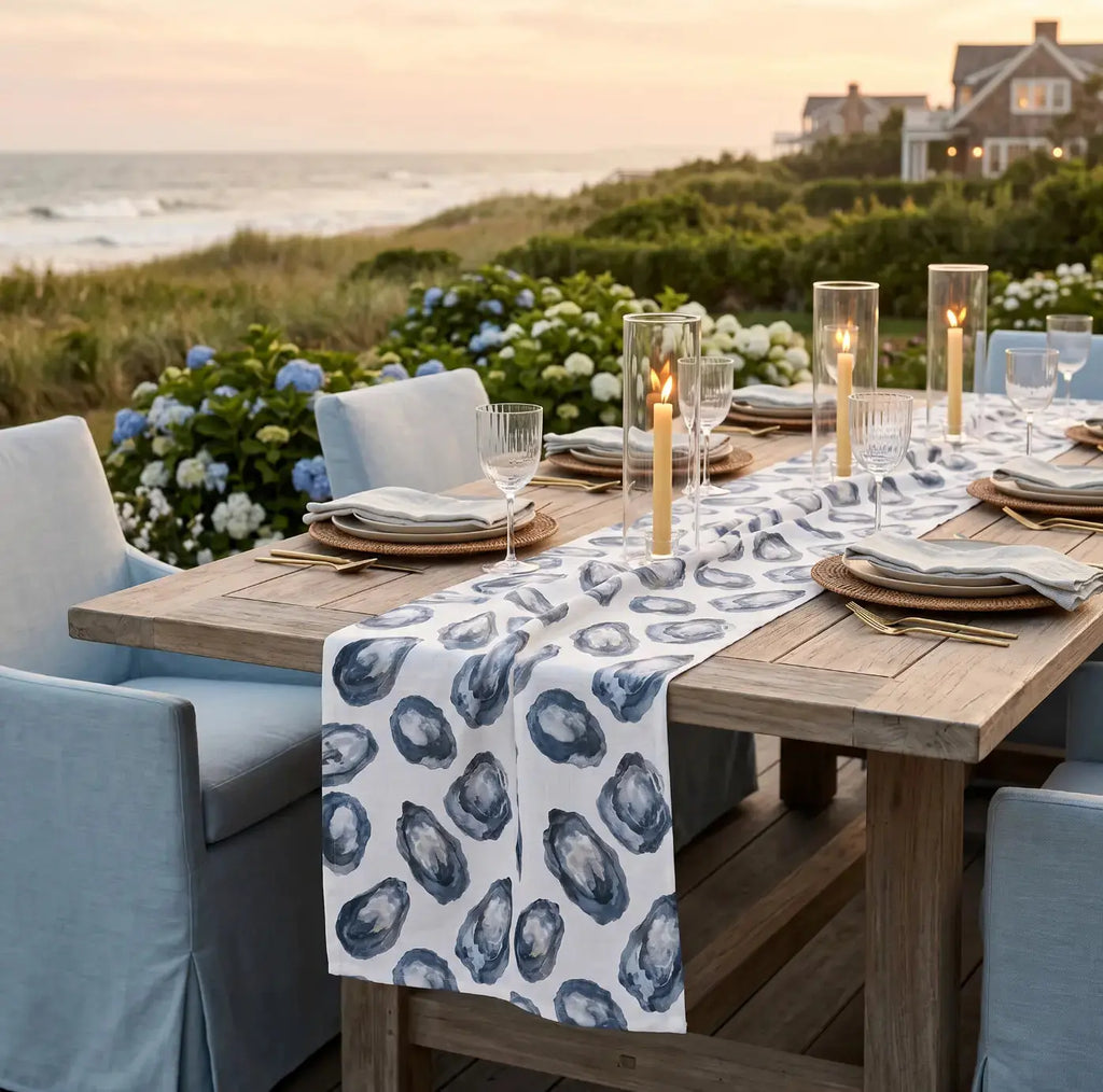 Navy and white oyster table runner on a wood dining table for nautical decor.