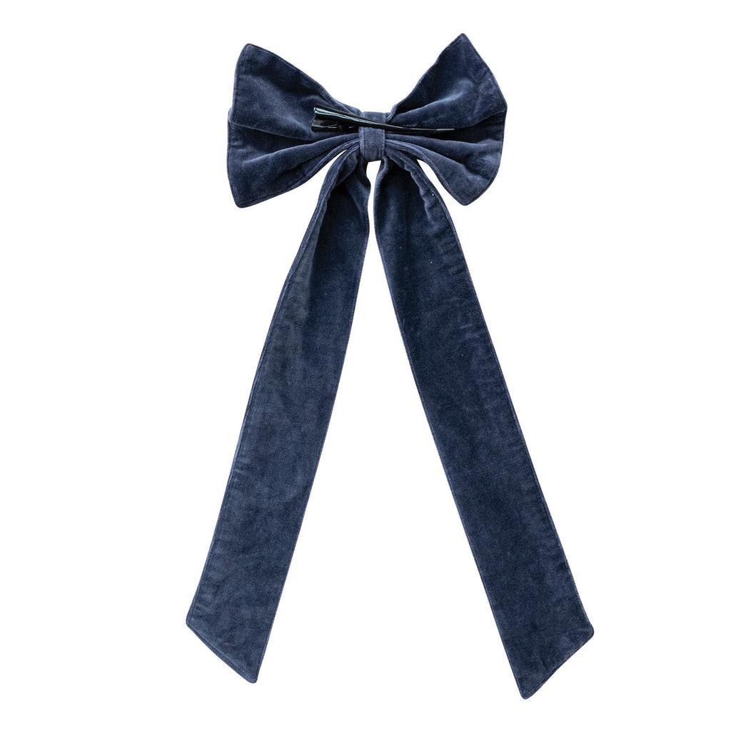 Navy cotton velvet bow adding a sophisticated finishing touch to a holiday gift display.