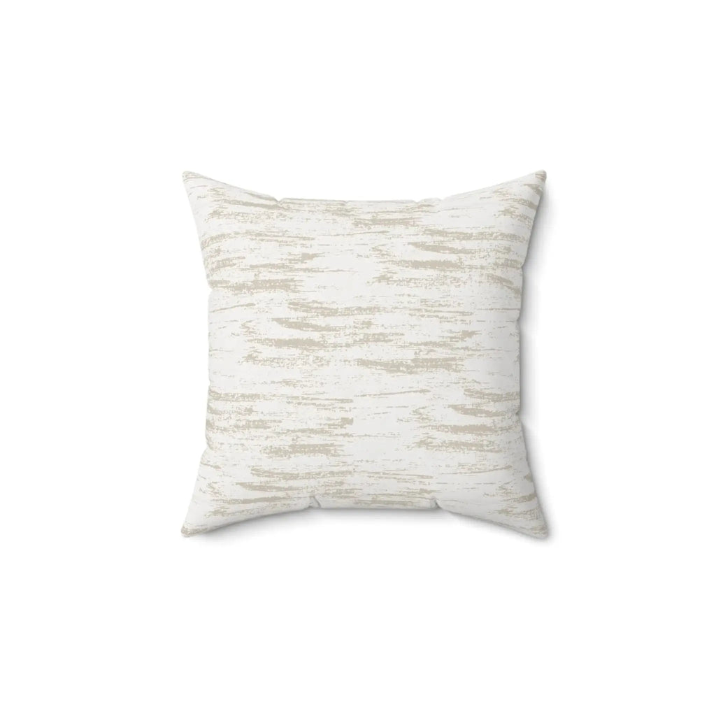 Neutral brushstroke throw pillow styled on a light sofa in a modern living room.