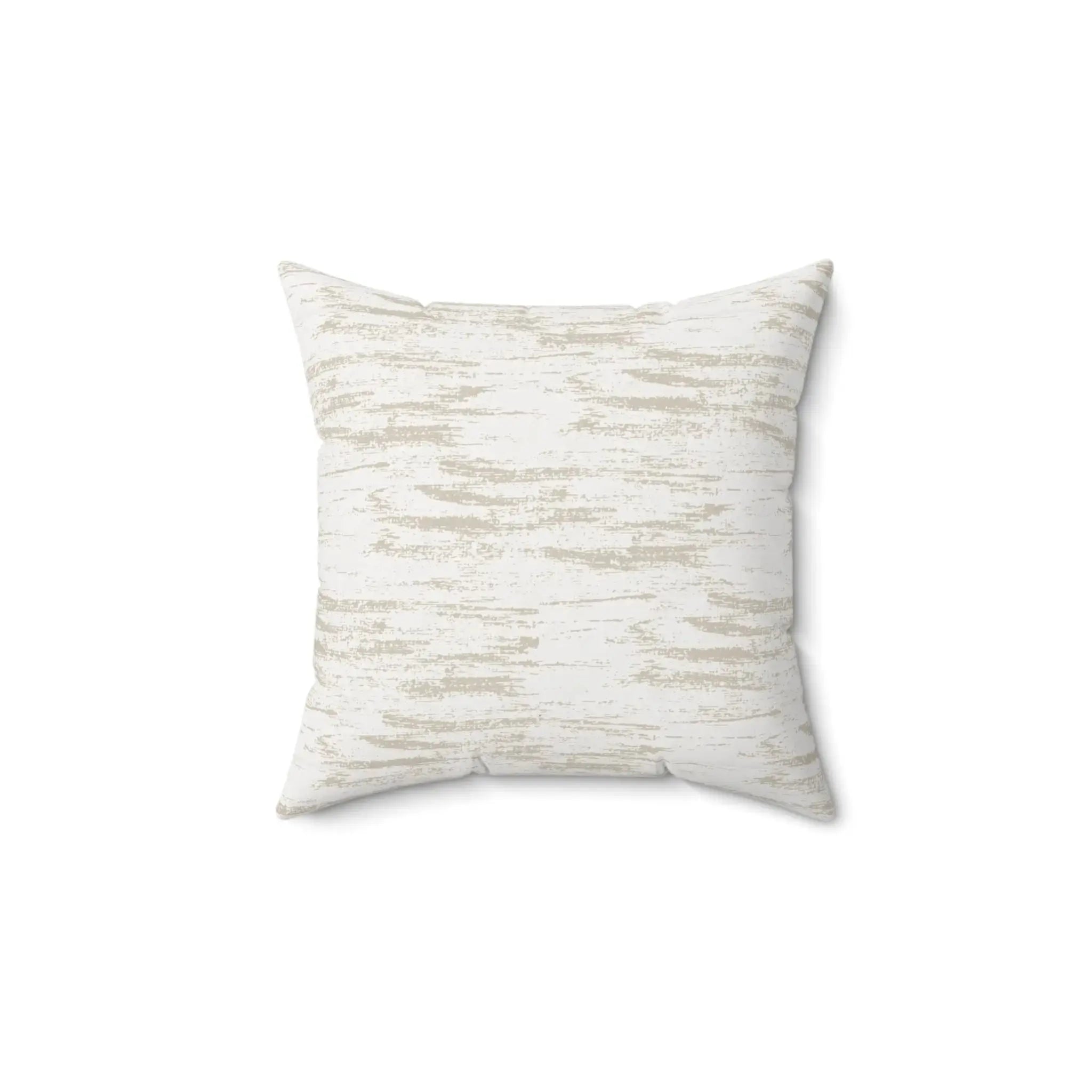 Neutral brushstroke throw pillow styled on a light sofa in a modern living room.