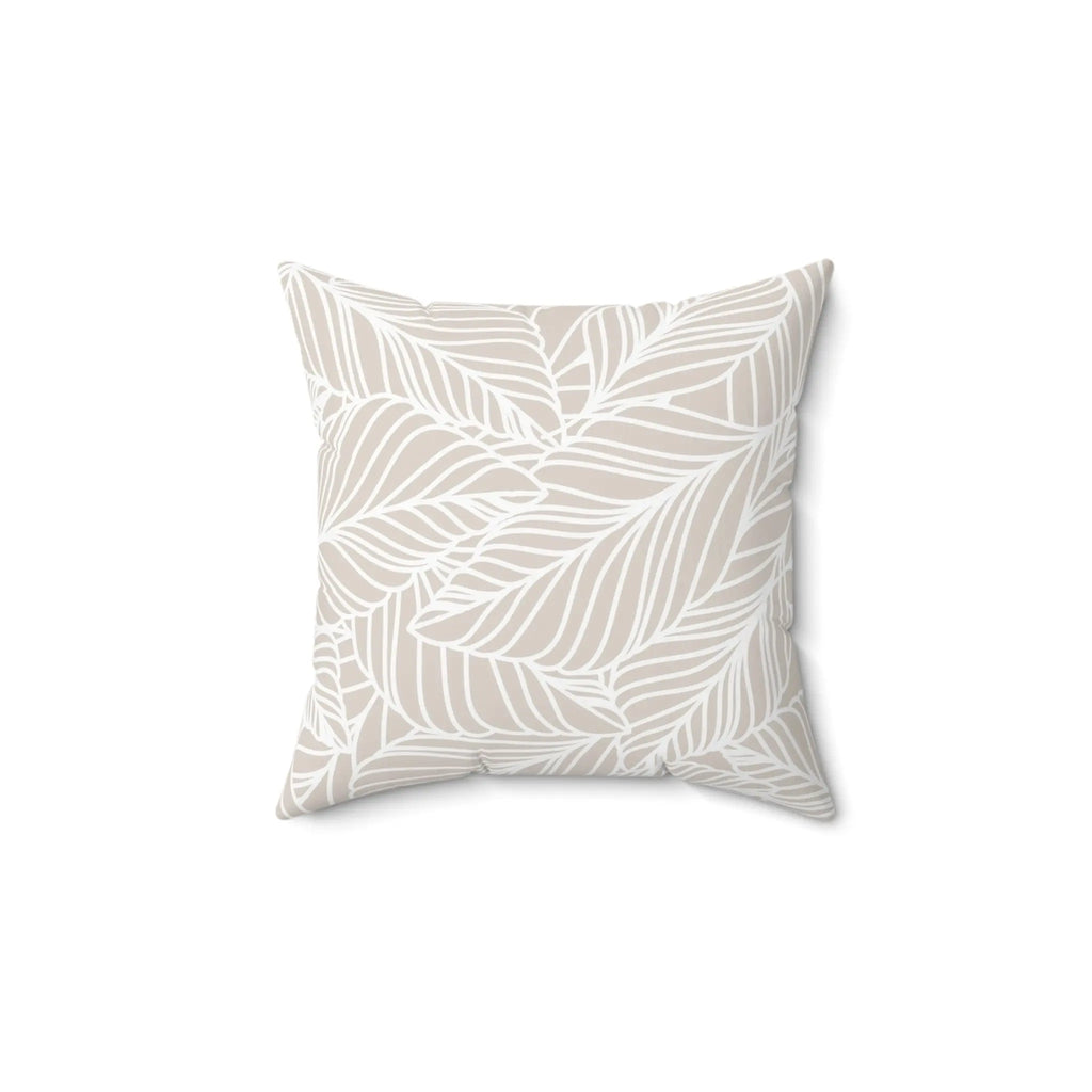 Beige leaf-pattern throw pillow with white leaf outlines on a sand-toned background.