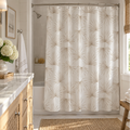 Neutral palm pattern shower curtain styled in a coastal bathroom