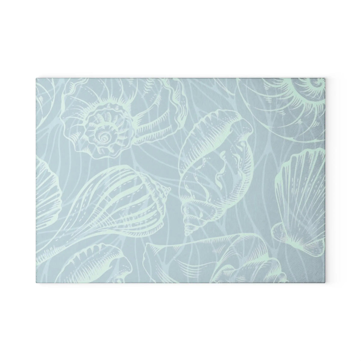 Tempered glass cutting board in seafoam tones with white seashell outlines.