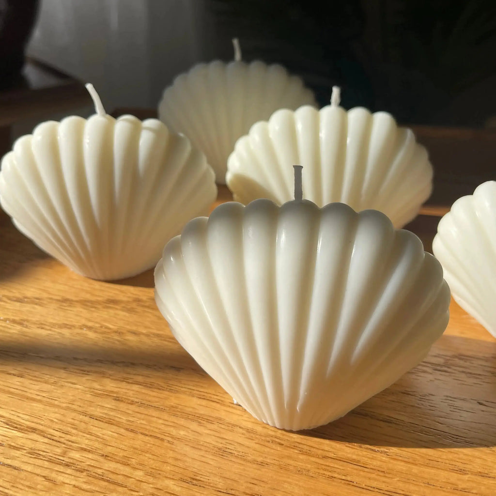 seashell candle used as coastal home decor accent