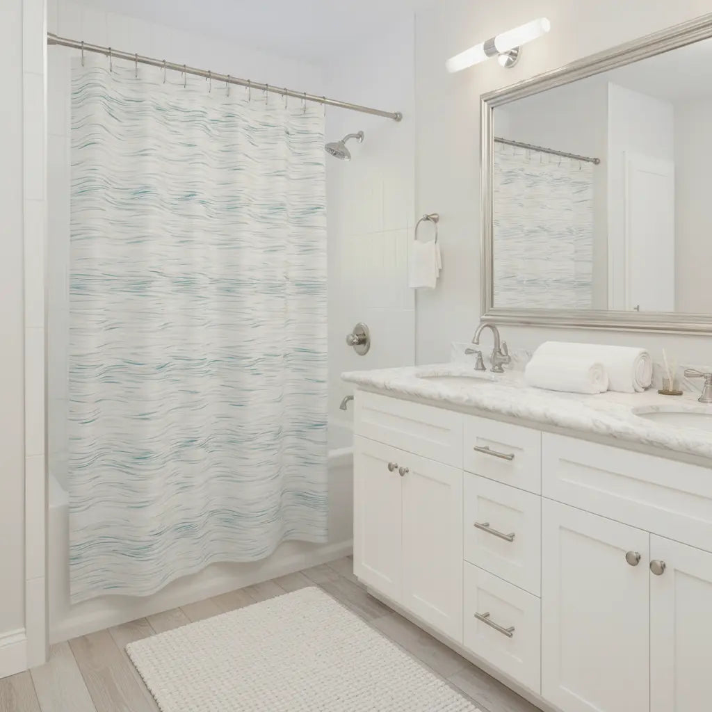 Coastal Breeze Shower Curtain with pale blue watercolor ripple on white bathroom backdrop, 100% polyester.