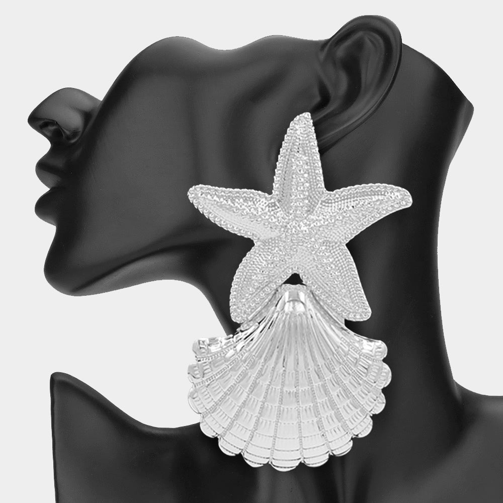 Oversized silver textured starfish earrings shown as coastal glam statement jewelry