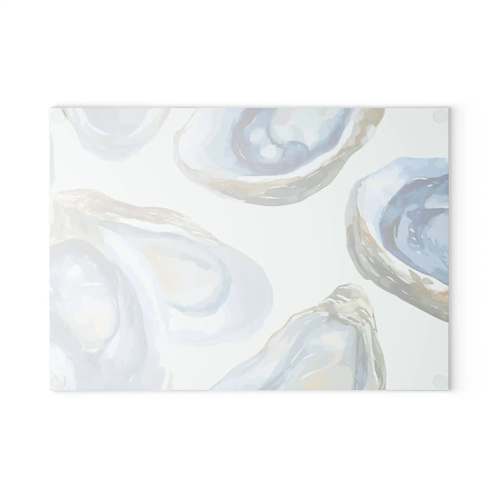 Oyster Cutting Board by pale blue oyster shell motif on a white cutting board.