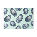 Oyster-pattern tempered glass cutting and serving board with blue oyster motifs on a pale mint background.
