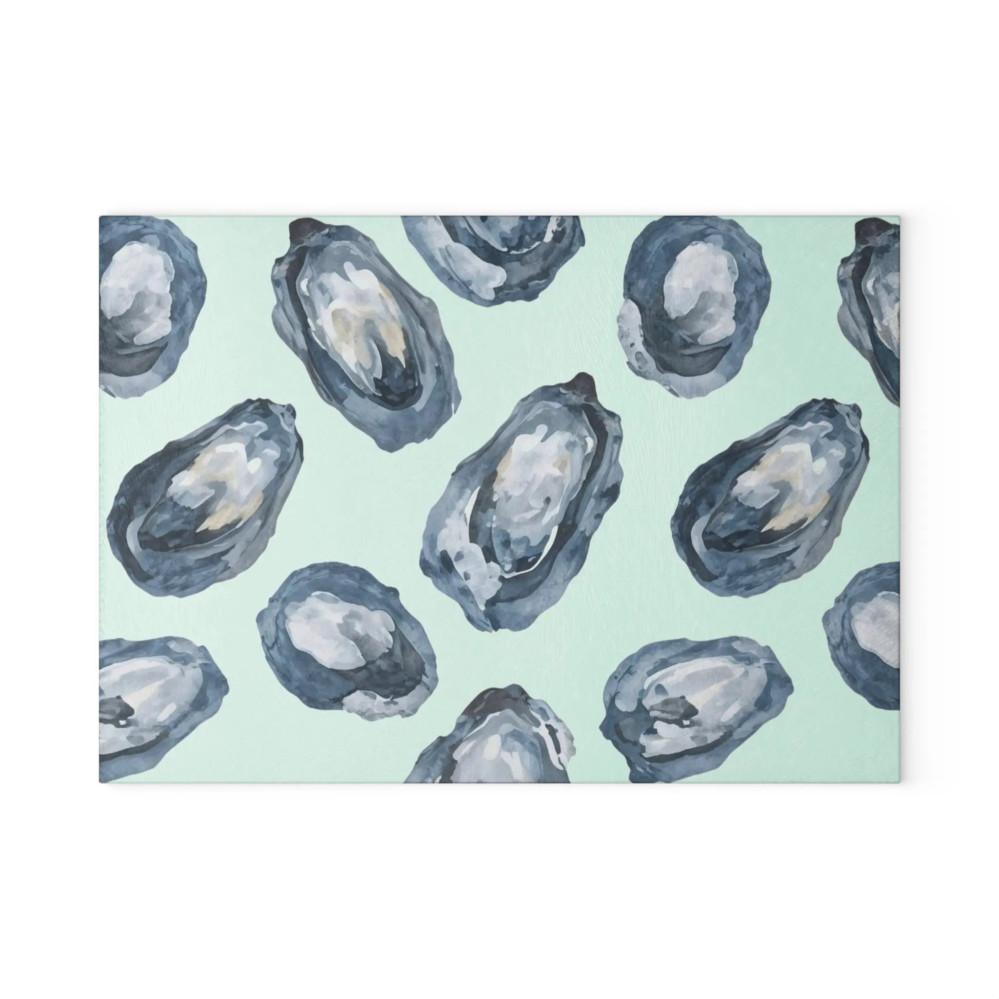 Oyster-pattern tempered glass cutting and serving board with blue oyster motifs on a pale mint background.
