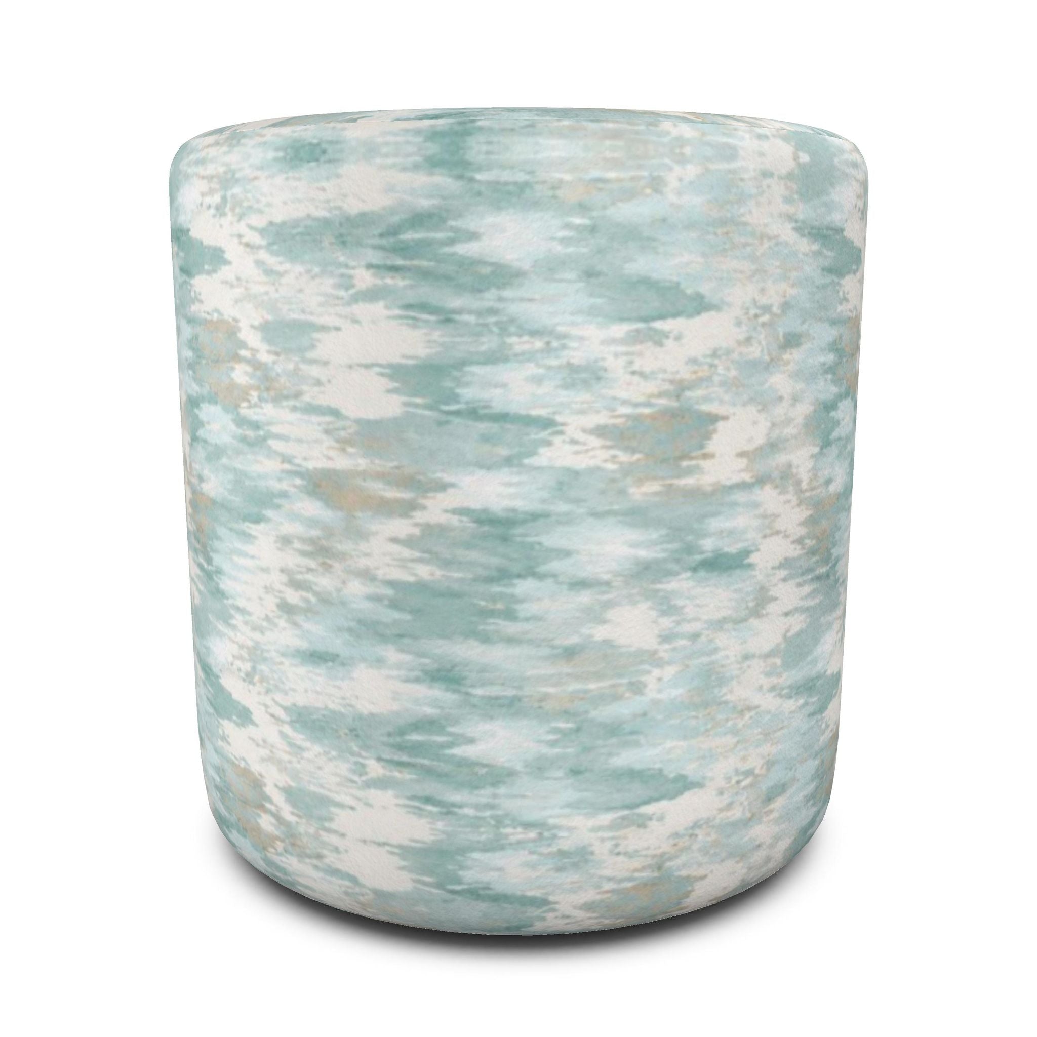 Blue abstract-pattern round ottoman paired with white furniture, natural wood, and seaside-inspired décor.