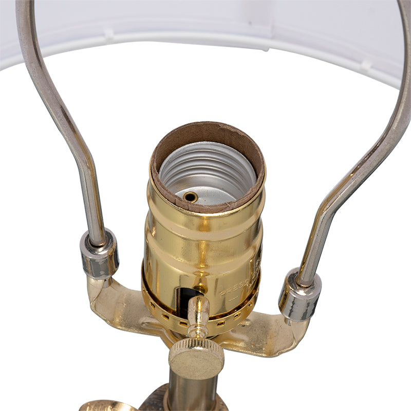 Sculptural gold leaf table lamp styled in a refined Palm Beach-inspired home.