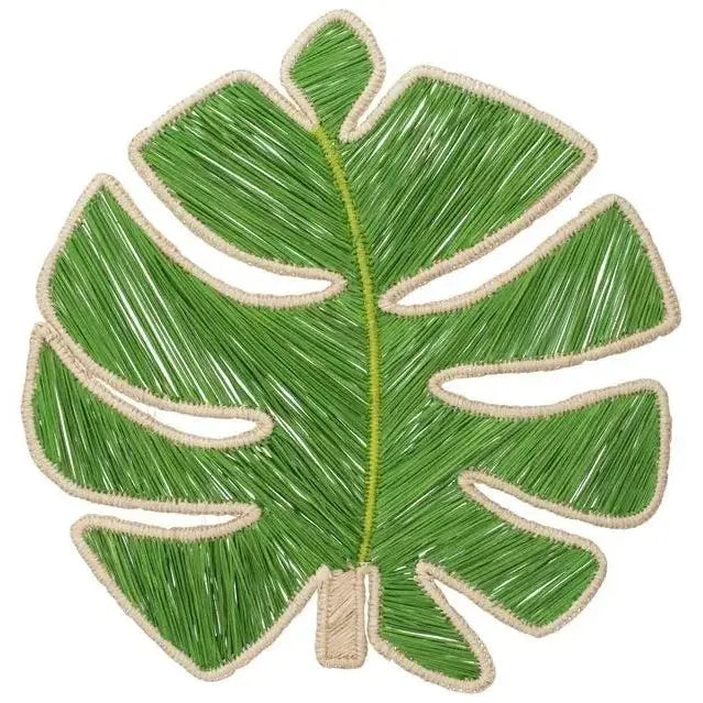 Handwoven Monstera Leaf Iraca placemat on a wood dining table in a beach house