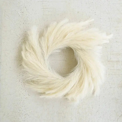 Boho style pampas grass wreath in white and yellow tones for year-round decor.