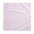 Pink and white gingham tablecloth on a coastal kitchen table with casual place settings