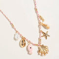 Pearl seashell starfish seahorse charm station necklace on a twisted fabric chain in coastal nautical style